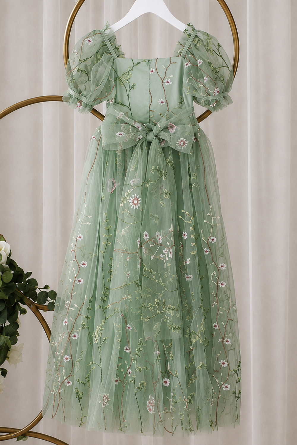 sage floral flower girl dress showing back of dress with big bow.