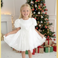 Girls white Christmas dress for holiday parties and family photos. In a short puffy sleeve style with shiny organza material for a knee length look. 