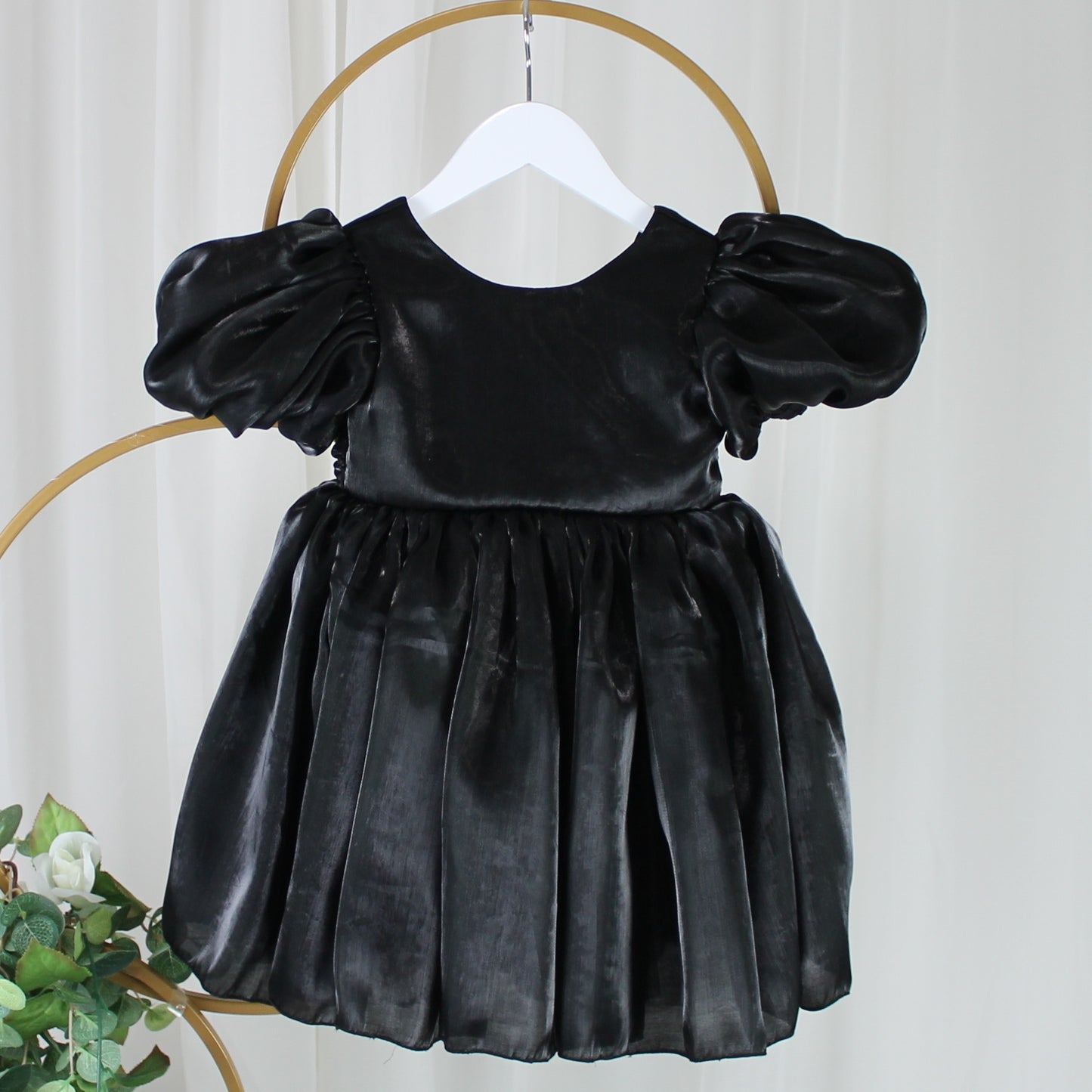 black flower girl dress with puffy sleeves and big bow. 