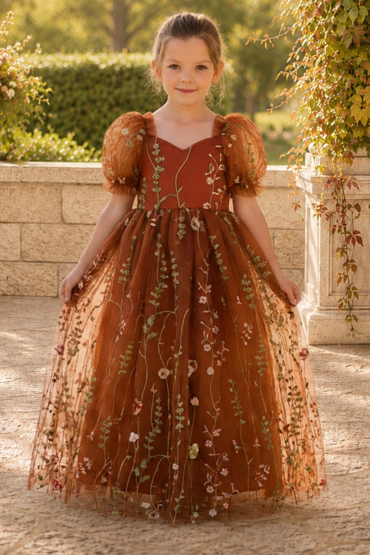 flower girl dress in burnt orange floral embroidered tulle. Featuring a sweat heart neckline, puffy short sleeves and a full length dress.