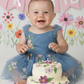 embroidered first birthday dress. Dusty blue floral baby girl romper style dress with built in bodysuit.  