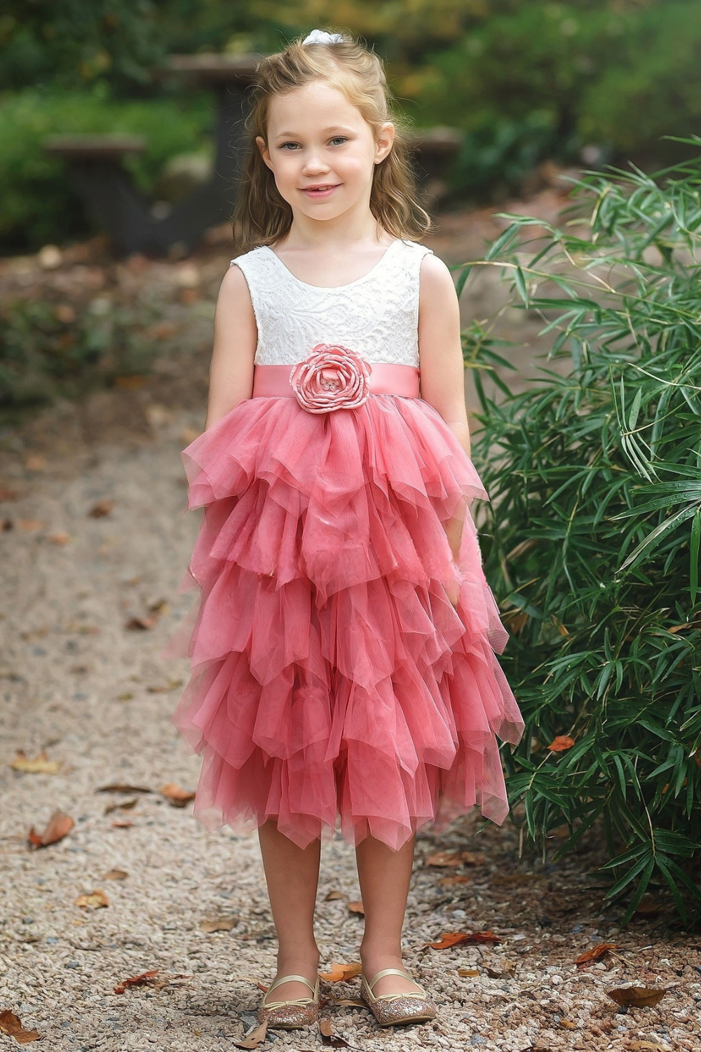 dusty rose flower girl dress in a tiered tutu style with white lace sleeveless style. 