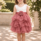 flower girl dress in dusty rose tulle in a tiered tutu style. Top bodice of a soft white lace sleeveless style dress