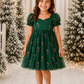 Girls Christmas dress in green tulle with red and gold glitter candy canes, sweetheart neckline, puff sleeves and knee-length skirt.