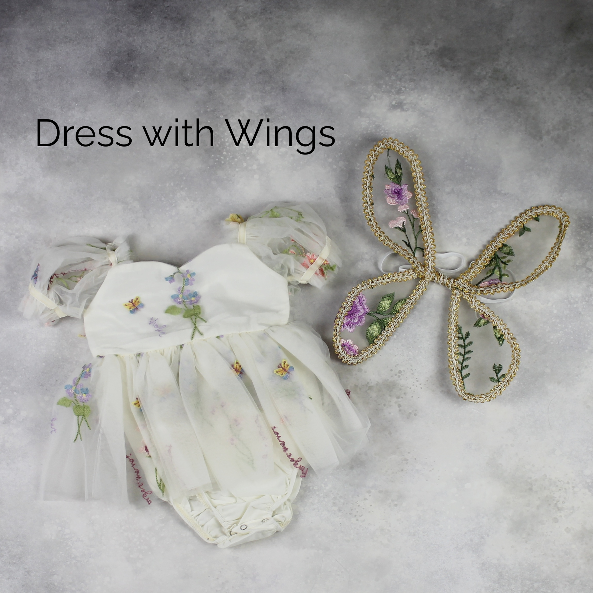 Fairy First birthday baby girls romper dress in ivory floral with wings. 