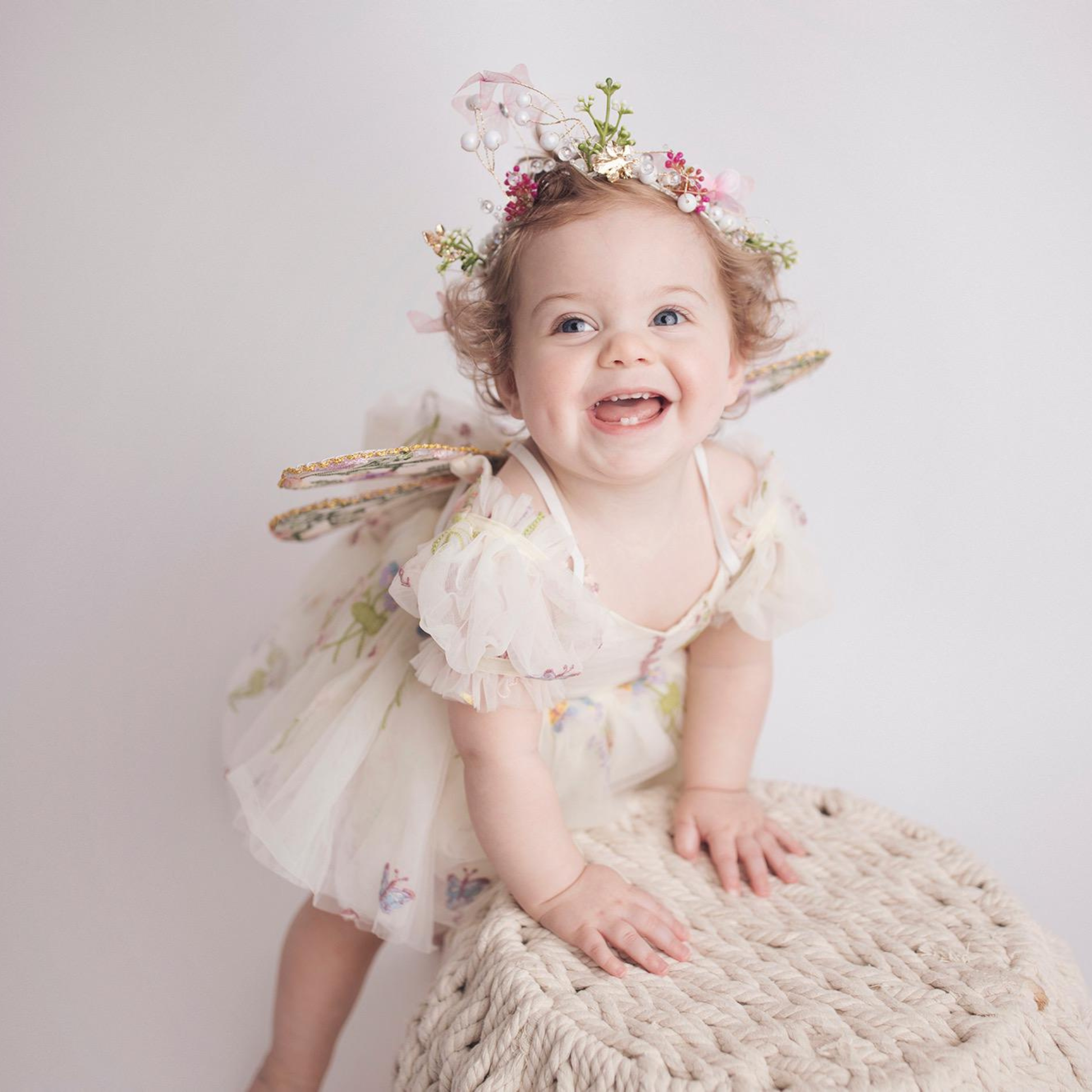 Fairy First birthday baby girls romper dress in ivory floral with wings. 