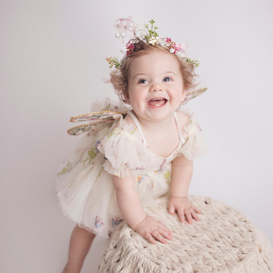 Fairy First birthday baby girls romper dress in ivory floral with wings. 