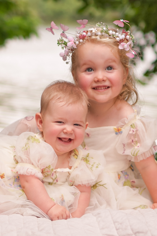Floral flower girl dress in ivory tulle with puffy sleeves and bow