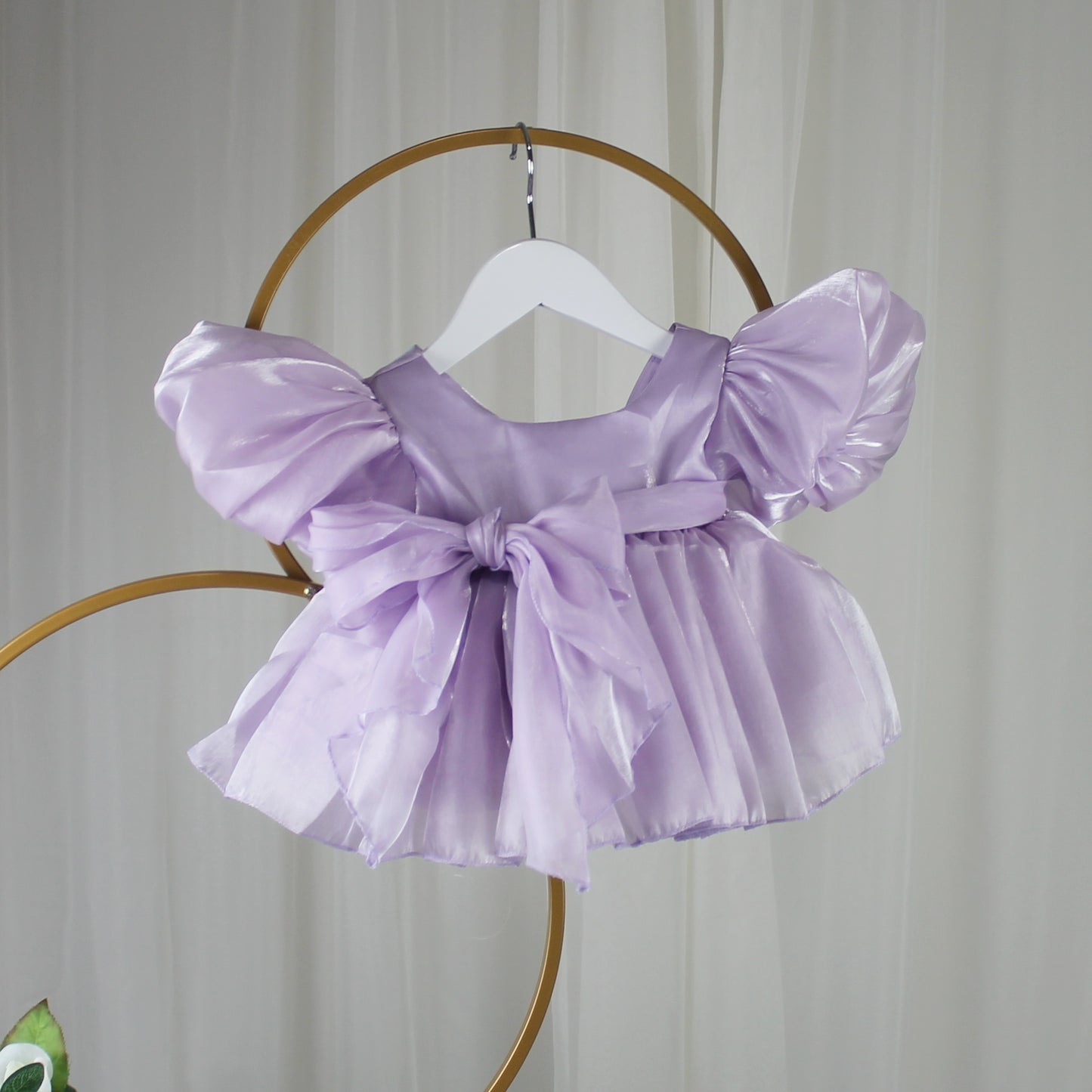 Lavender baby girl dress with puff sleeves and a bow. First birthday dress in Organza 