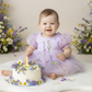 First birthday baby girl dress in lavender floral tulle with built in romper/bodysuit and puffy  short sleeves.