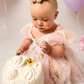 Wildflower first birthday baby girl dress in light pink embroidered flowers. 
