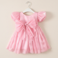 light pink girls dress with puffy sleeves and big bow for birthdays and special occasions. 