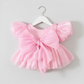 light pink baby girl dress with puffy sleeves and big bow for birthdays and special occasions. 