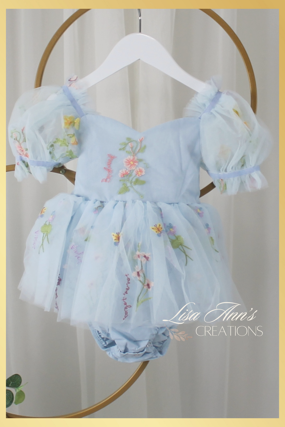 Baby girl dress in a light blue floral tulle. Perfect for a baby first birthday dress. 
