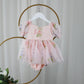 1st birthday baby girl romper in light pink floral for a fairy or garden party theme. 