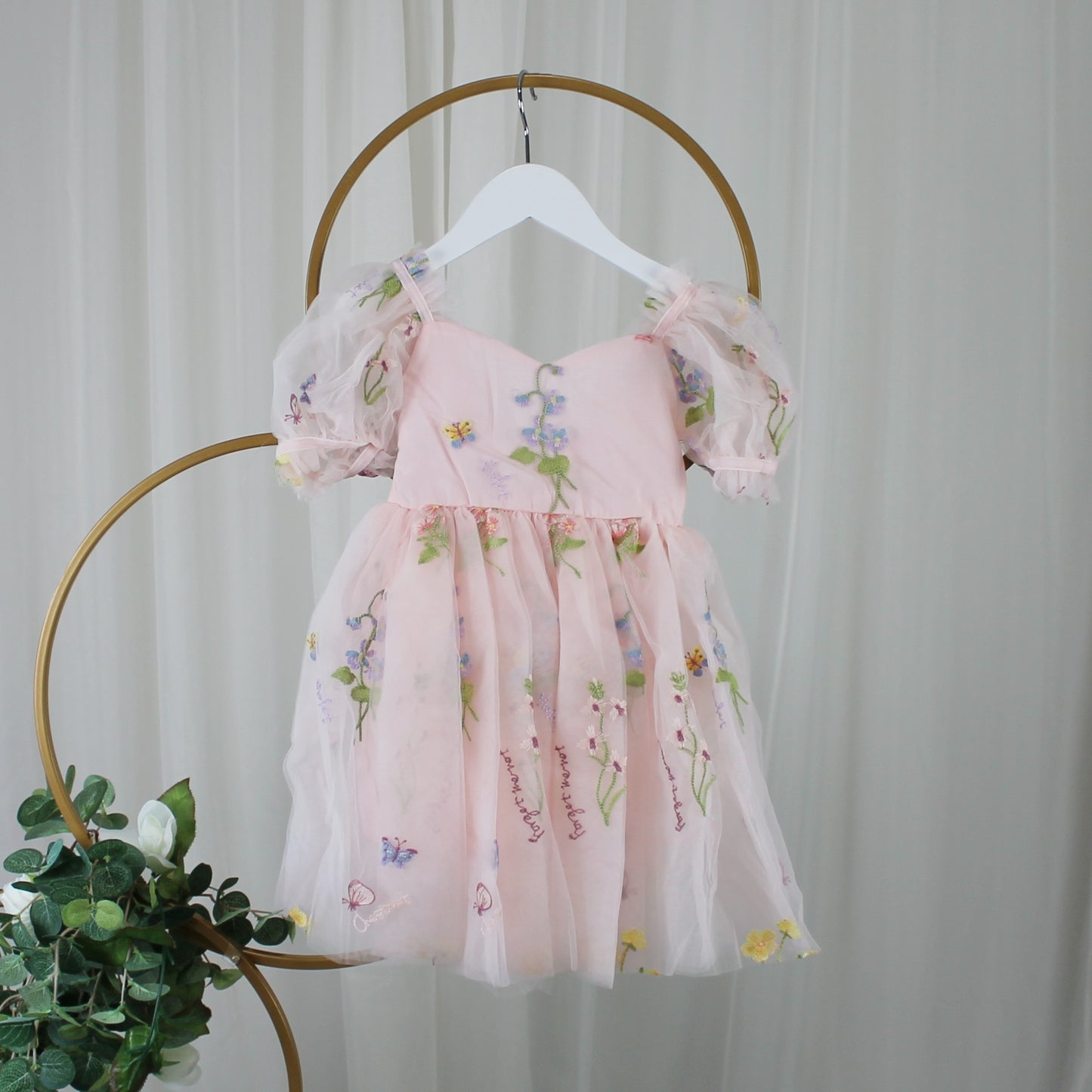 1st birthday baby girl romper in light pink floral for a fairy or garden party theme. 