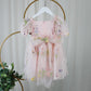 1st birthday baby girl romper in light pink floral for a fairy or garden party theme. 