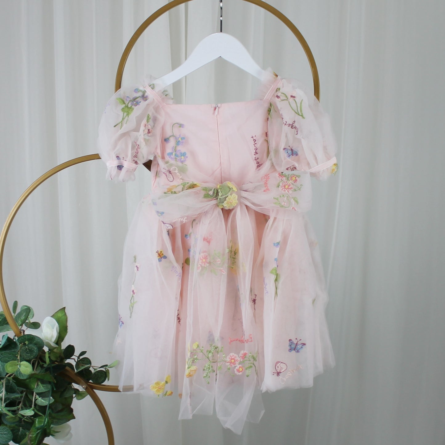 1st birthday baby girl romper in light pink floral for a fairy or garden party theme. 