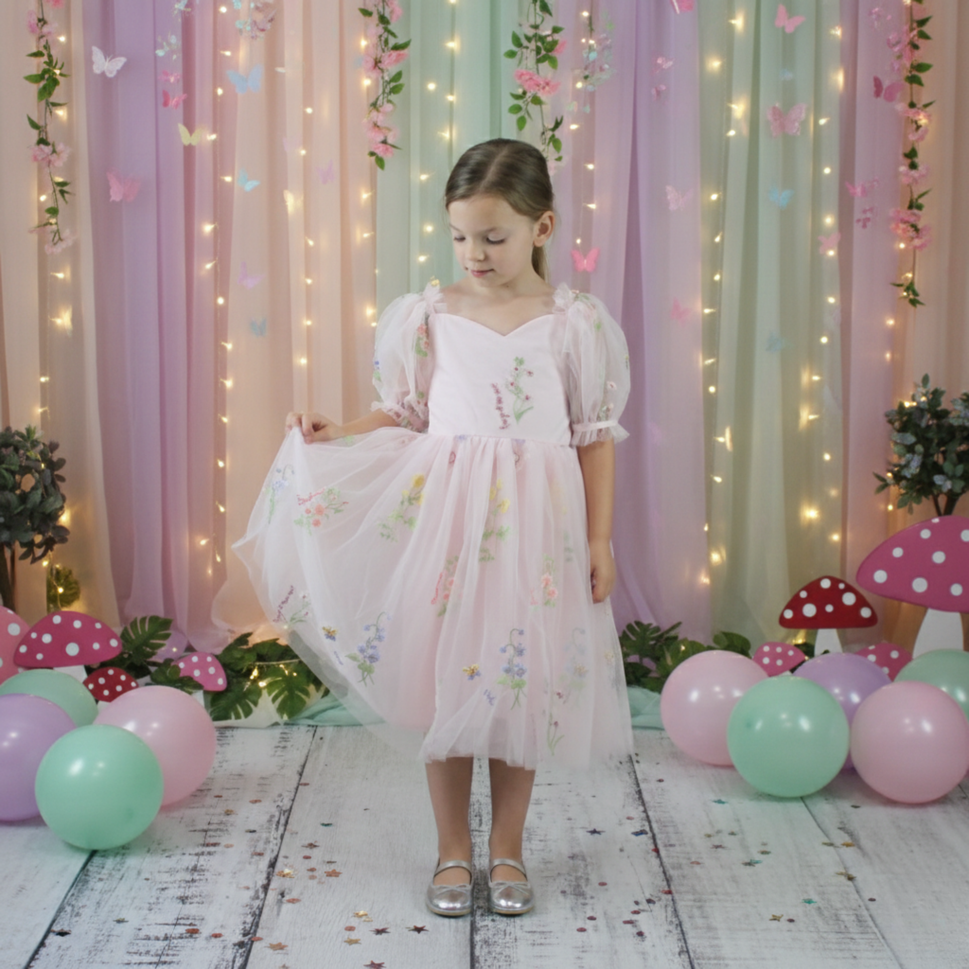 1st birthday baby girl romper in light pink floral for a fairy or garden party theme. 