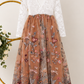 flower girl dress in burnt orange embroidered florals, sequins and tulle. Long sleeve white lace bodice and full length dress.  