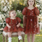 Flower girl dress in rust floral embroidery tulle with puffy sleeves and big bow. 