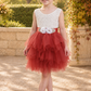 Flower girl dress in rust tulle tiered tutu style with white lace sleeveless top. 