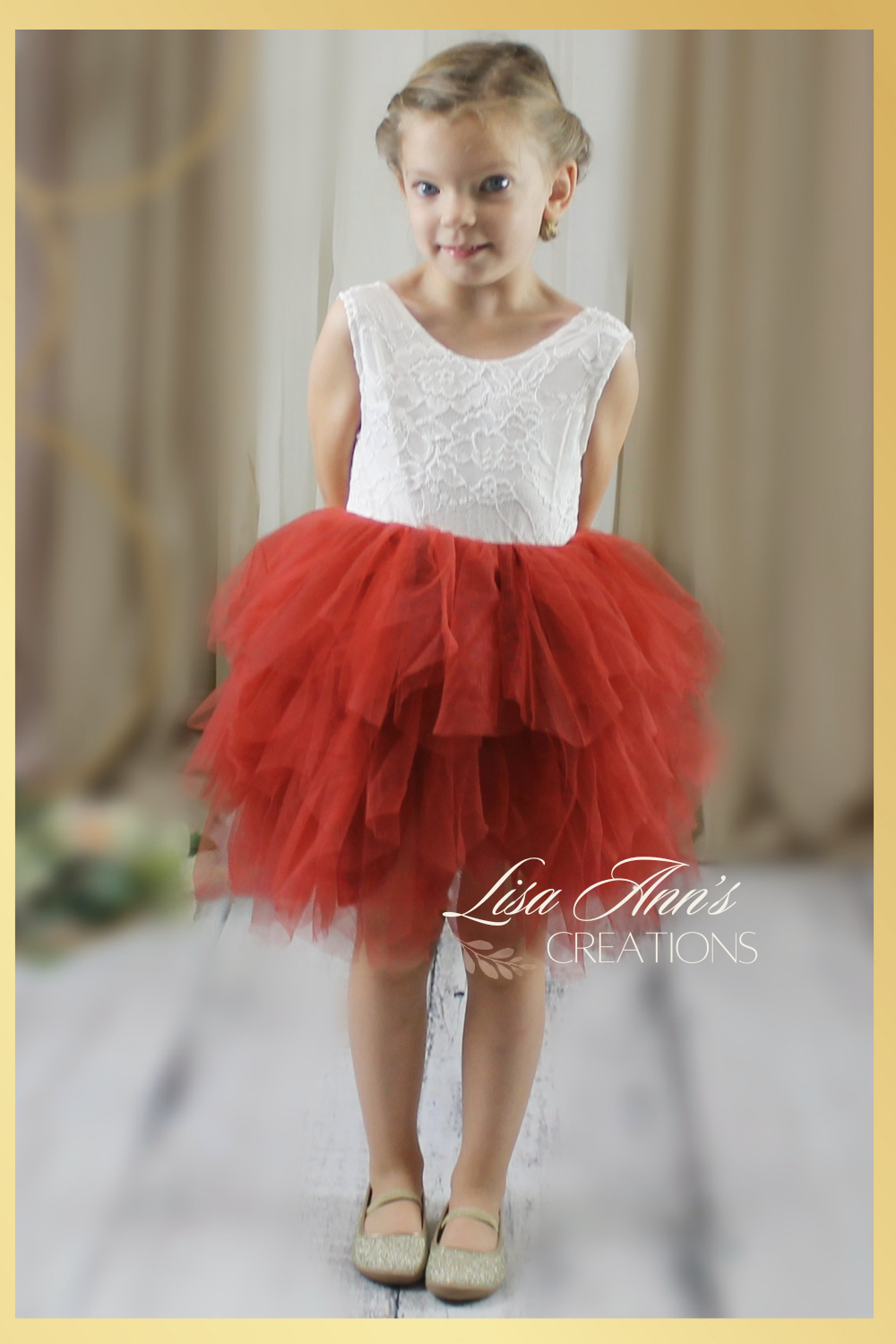Flower girl dress in a rust tulle tiered skirt style. top bodice in a white lace sleeveless cut. 