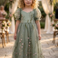Sage flower girl dress in a full length style with puffy sleeves and big bow. 