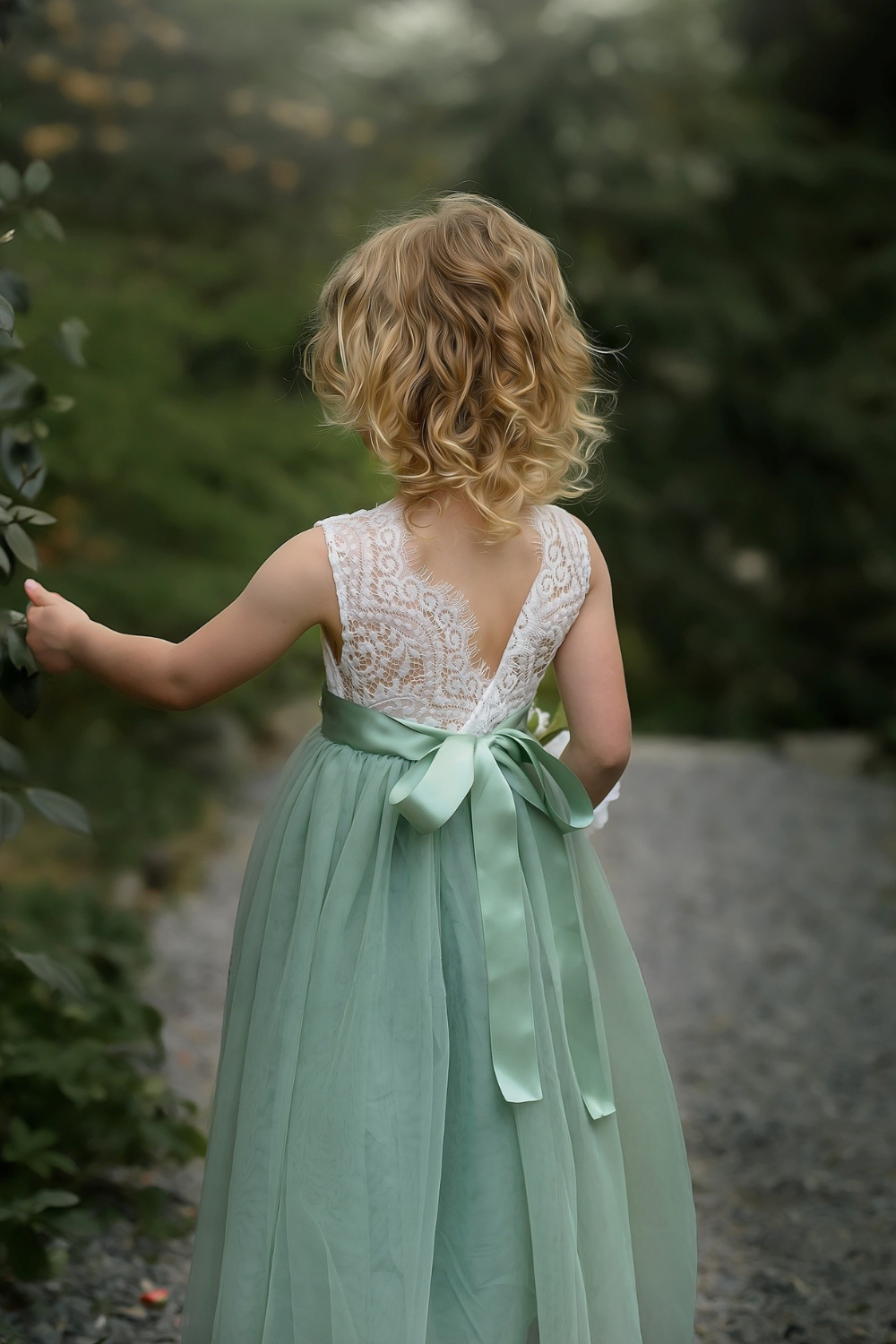 Sage green flower girl dress in tulle with sleeveless white lace. 