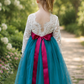 Tulle flower girl dress in teal with white lace bodice and full length skirt and v shaped back. 