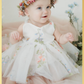 Baby girl first birthday fair dress in white florals.