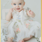 Baby girl first birthday fair dress in white florals.