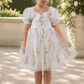 wildflower flower girl dress in white embroidered florals, knee length style dress with big puffy short sleeves. 