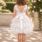 white flower girl dress in a lace and tulle. A tutu tiered style knee length dress with a sleeveless white lace bodice