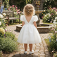 flower girl dress in white with puffy sleeves and big bow