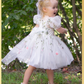 White floral girls and baby dress for flower girls, first birthdays and special occasions.  Sweetheart neckline, puffy sleeves, and knee length style in a fall floral tulle dress.