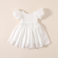 Girls white Christmas romper dress for holiday parties and family photos. In a short puffy sleeve style with shiny organza material for a knee length style