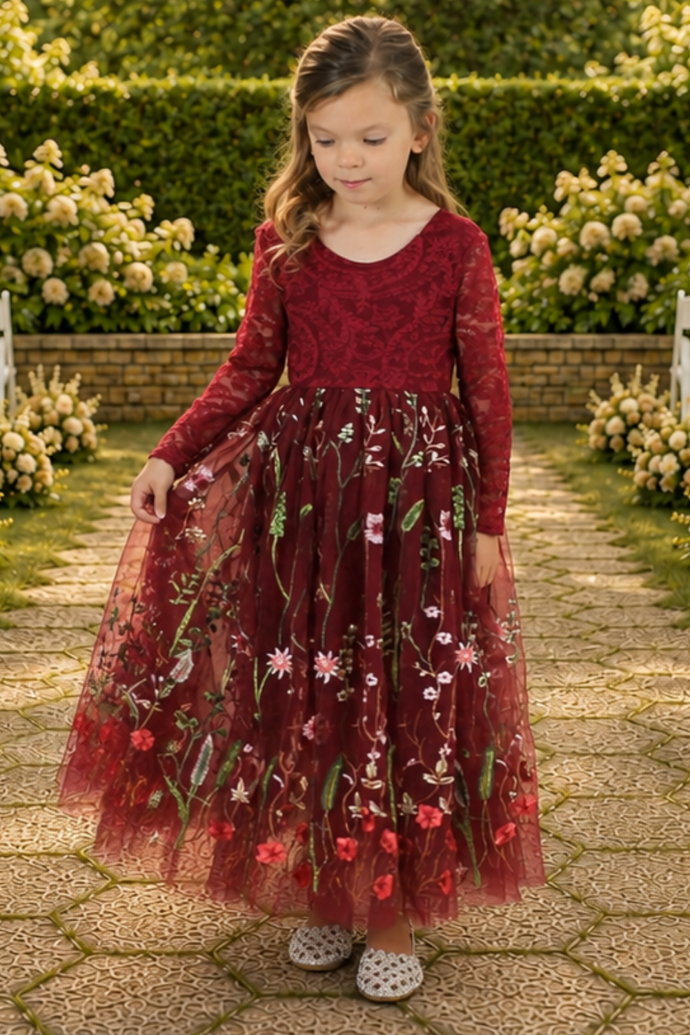 burgundy flower girl dress in embroidered floral burgundy tulle. Long lace sleeves and a full length style.