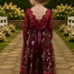 flower girl dress in embroidered floral burgundy tulle. Long lace sleeves and a full length style.