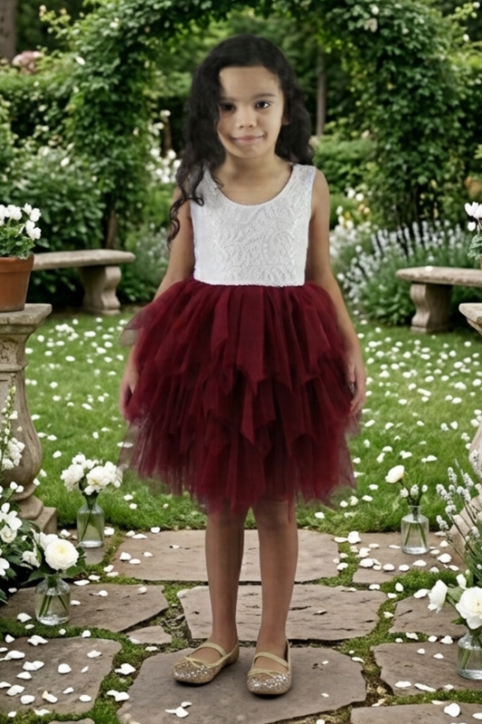 burgundy tulle flower girl dress in a tiered tutu style. Made knee length with a sleeveless white lace top. 