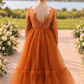 burnt orange flower girl dress in a mermaid style with long lace sleeves