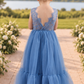dusty blue flower girl dress in tulle and lace. With a mermaid flair bottom in full length.