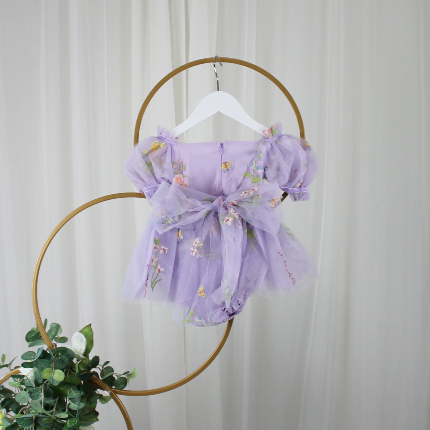 First birthday baby girl dress in lavender floral tulle with built in romper/bodysuit and puffy  short sleeves.