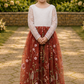 flower girl in rust floral embroidery tulle with long lace sleeves and full length dress. 
