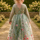 flower girl dress in sage green floral tulle with an embroidered floral pattern. Lace long sleeves and a full tulle length. 