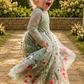 fall flower girl dress in sage green floral tulle with an embroidered floral pattern. Lace long sleeves and a full tulle length. 