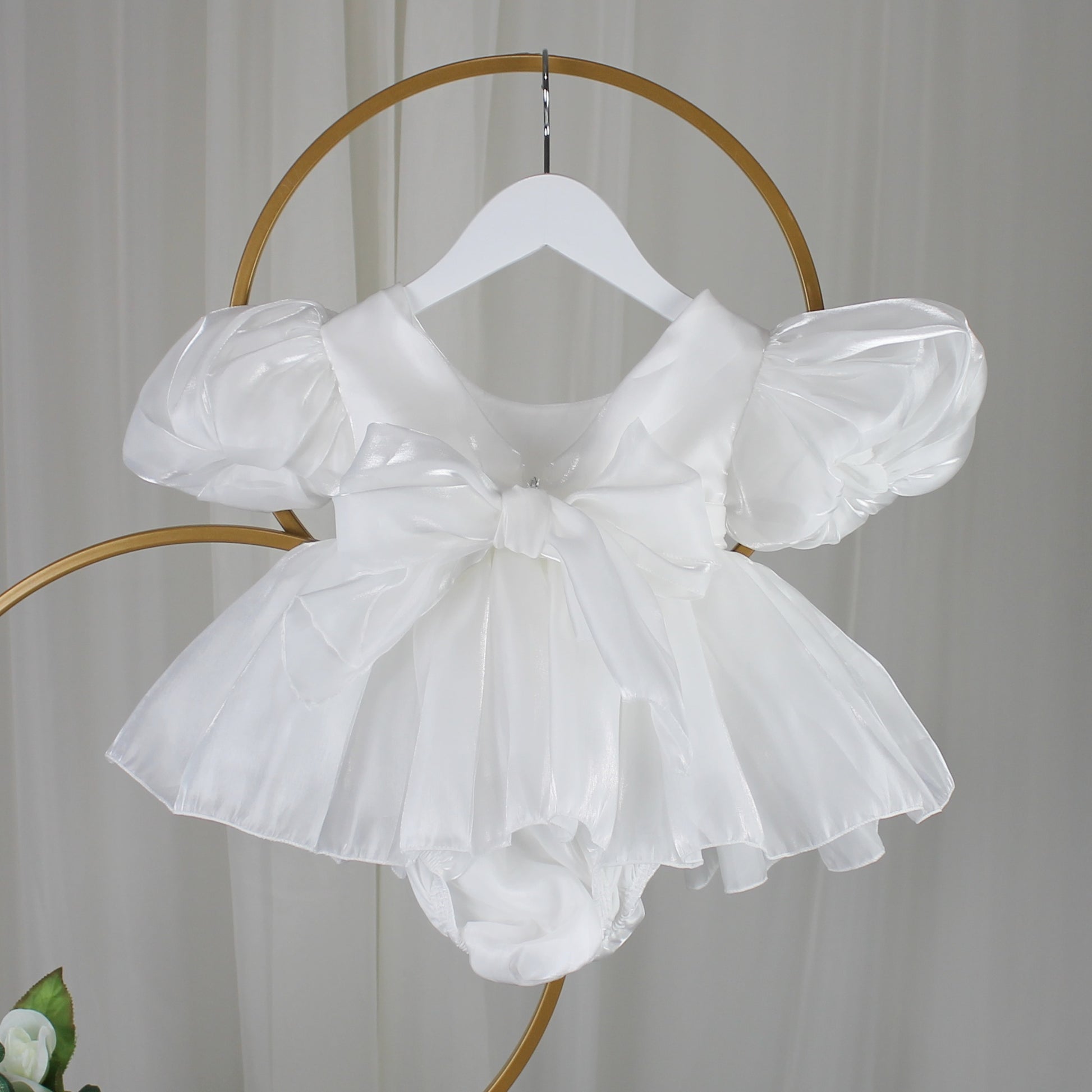 Baby Girls white Christmas romper dress for holiday parties and family photos. In a short puffy sleeve style with shiny organza material for a short midi thigh style